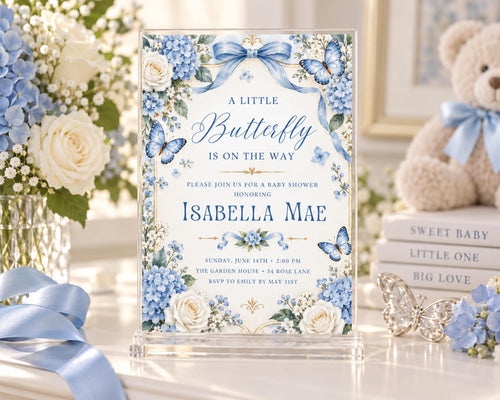 A blue and white baby shower invitation for a baby shower for Isabela Mae, featuring a floral design with blue and white flowers and butterflies.