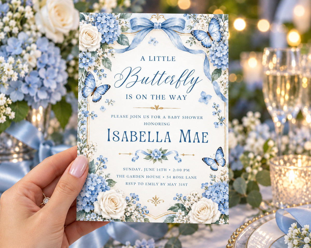 A hand holding a baby shower invitation with a floral design and text.