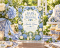 a beautifully decorated baby shower invitation with a floral theme, surrounded by various desserts and flowers.