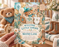 A hand holding a baby shower invitation featuring a teddy bear, balloons, and a basket with a baby.