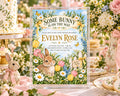 The image is a baby shower invitation featuring a bunny and flowers, with a pink and white color scheme.