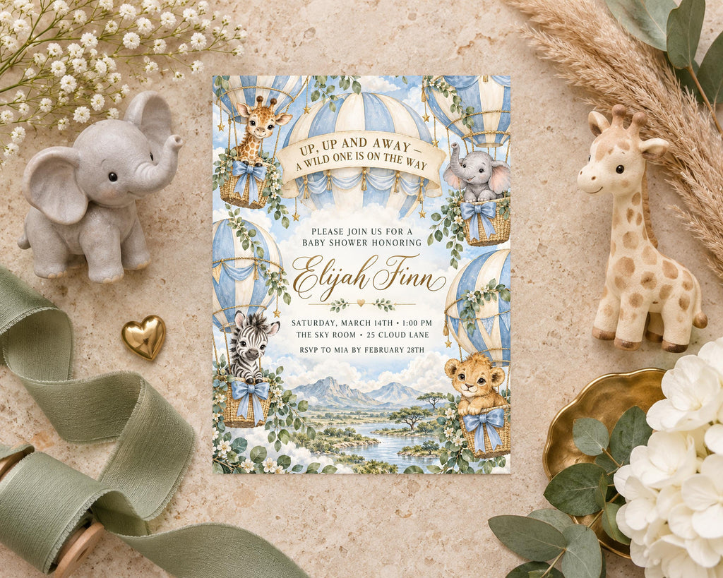 a baby shower invitation with illustrations of elephants, giraffes, and other animals, along with a landscape scene. The invitation is surrounded by various baby-related items, such as a stuffed elephant, a stuffed giraffe, and a heart-shaped ornament.