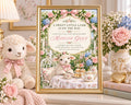 A framed invitation for a baby shower for a girl named Madeline Grace, featuring a charming illustration of a lamb and a tea party scene with flowers and pastel colors.