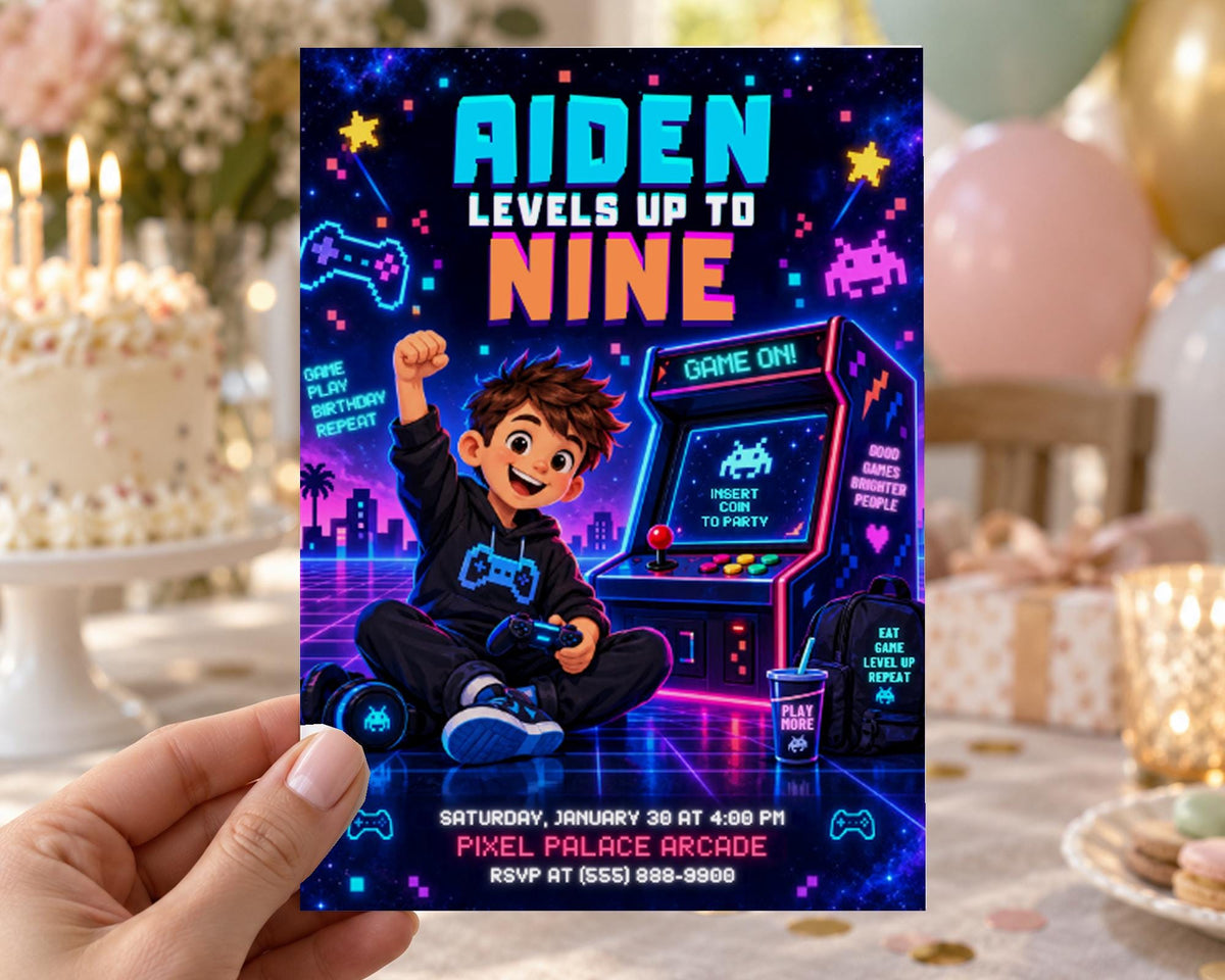 A hand holding a colorful invitation card for a birthday party with a boy playing a video game.