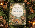 The image is a birthday invitation featuring a forest scene with various animals, including deer, foxes, and bears, surrounded by pine cones, mushrooms, and other natural elements.