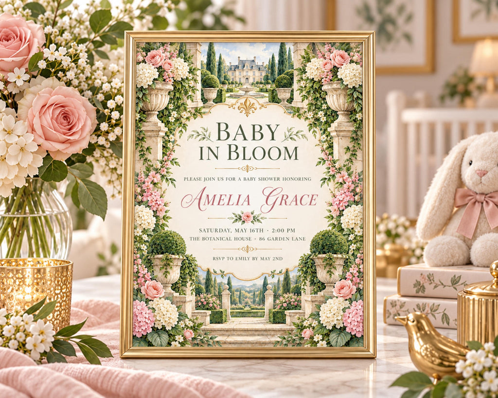 a framed baby shower invitation with a garden scene and pink flowers, placed on a table with a vase of flowers and a stuffed rabbit.
