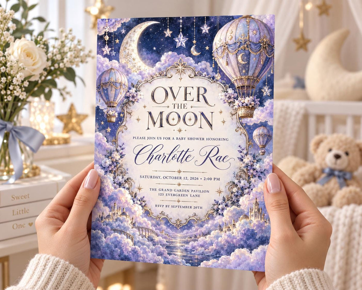 A person's hands holding a baby shower invitation with a moon and star theme, featuring a teddy bear and other decorative elements.