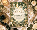 a beautifully designed invitation card for a baby shower, adorned with a moon and star motif, surrounded by flowers and other decorative elements.