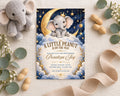 a baby shower invitation with a cute elephant on a crescent moon and stars, surrounded by a ribbon, peanuts, and a stuffed elephant toy.