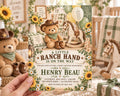 A hand holding a baby shower invitation featuring a teddy bear, rocking horse, and sunflowers, with the text "A LITTLE RANCH HAND IS ON THE WAY" and details about the baby shower event.