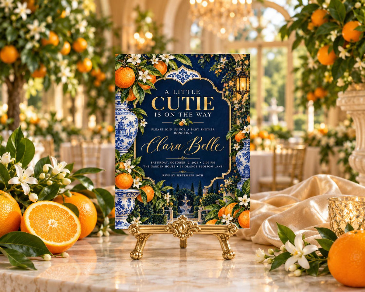 A decorative invitation card with a blue and white floral design, featuring oranges and flowers, placed on a table with oranges and white flowers.