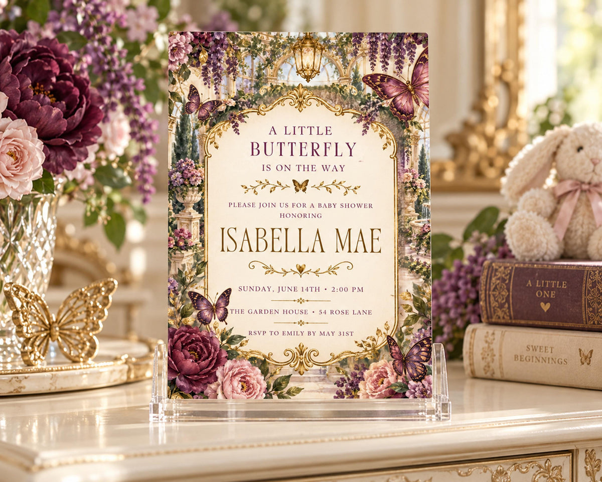 A decorative invitation card for a baby shower, featuring a floral design with purple and pink flowers, butterflies, and text inviting guests to a baby shower honoring Isabela Mae.