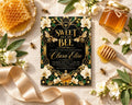 a honeycomb-themed baby shower invitation with a floral design, honey, and honeycomb elements.
