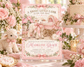 A pink baby shower invitation featuring a lamb and a carriage, surrounded by pink flowers and baby-themed decorations.