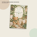 The image is an editable baby shower invitation featuring a teddy bear and various baby-related items, such as a basket, a blanket, and a teapot, all set against a backdrop of greenery and flowers.