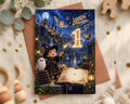 A birthday card featuring a young boy dressed as a wizard, surrounded by a magical castle, owls, and a book, with the text "Aiden is turning 1" prominently displayed.