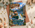 A birthday invitation featuring a cartoon image of a young boy fishing in a canoe, with mountains in the background and the text "Gabriel is turning 2" prominently displayed.